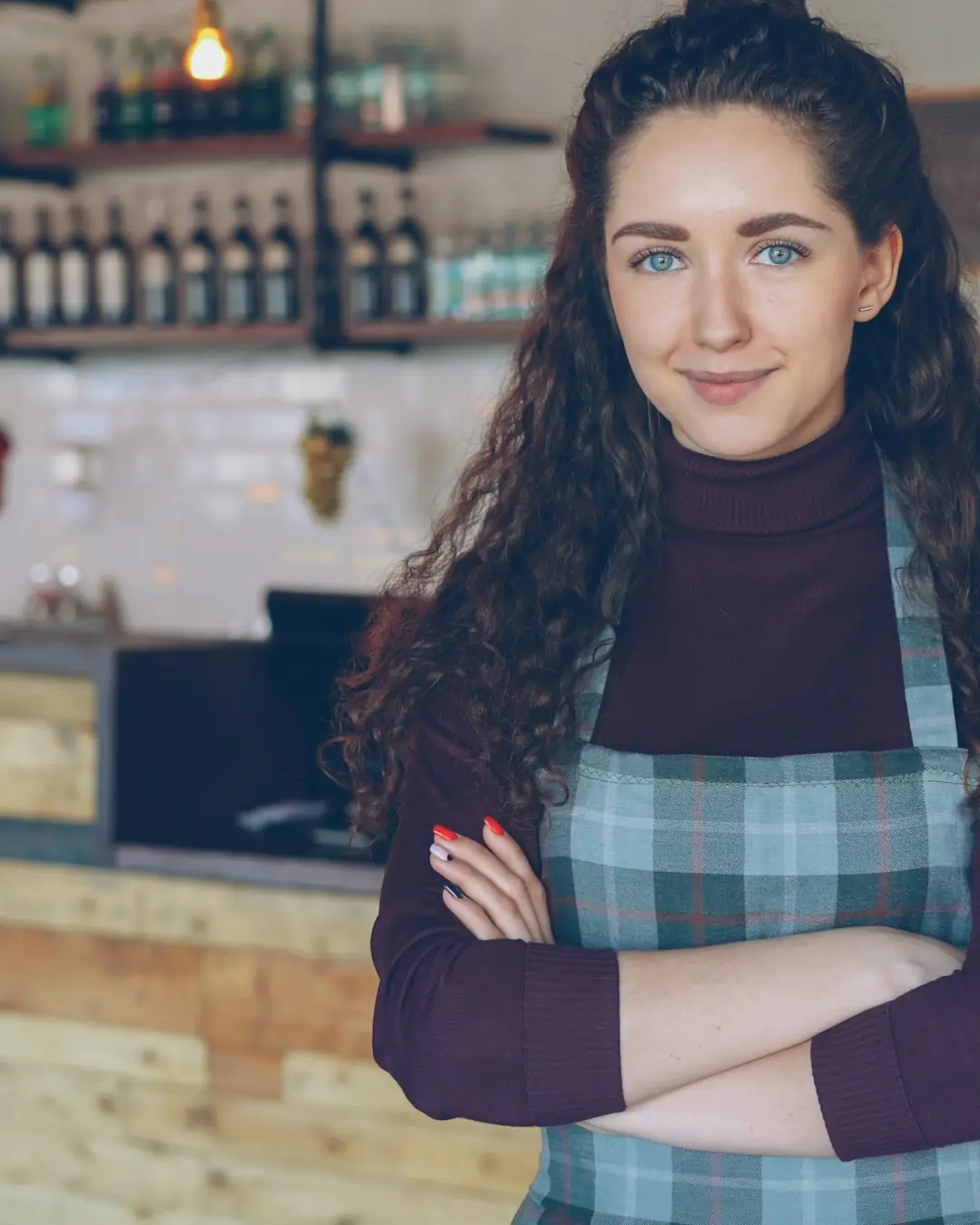 La titolare di un bar davanti al suo bancone